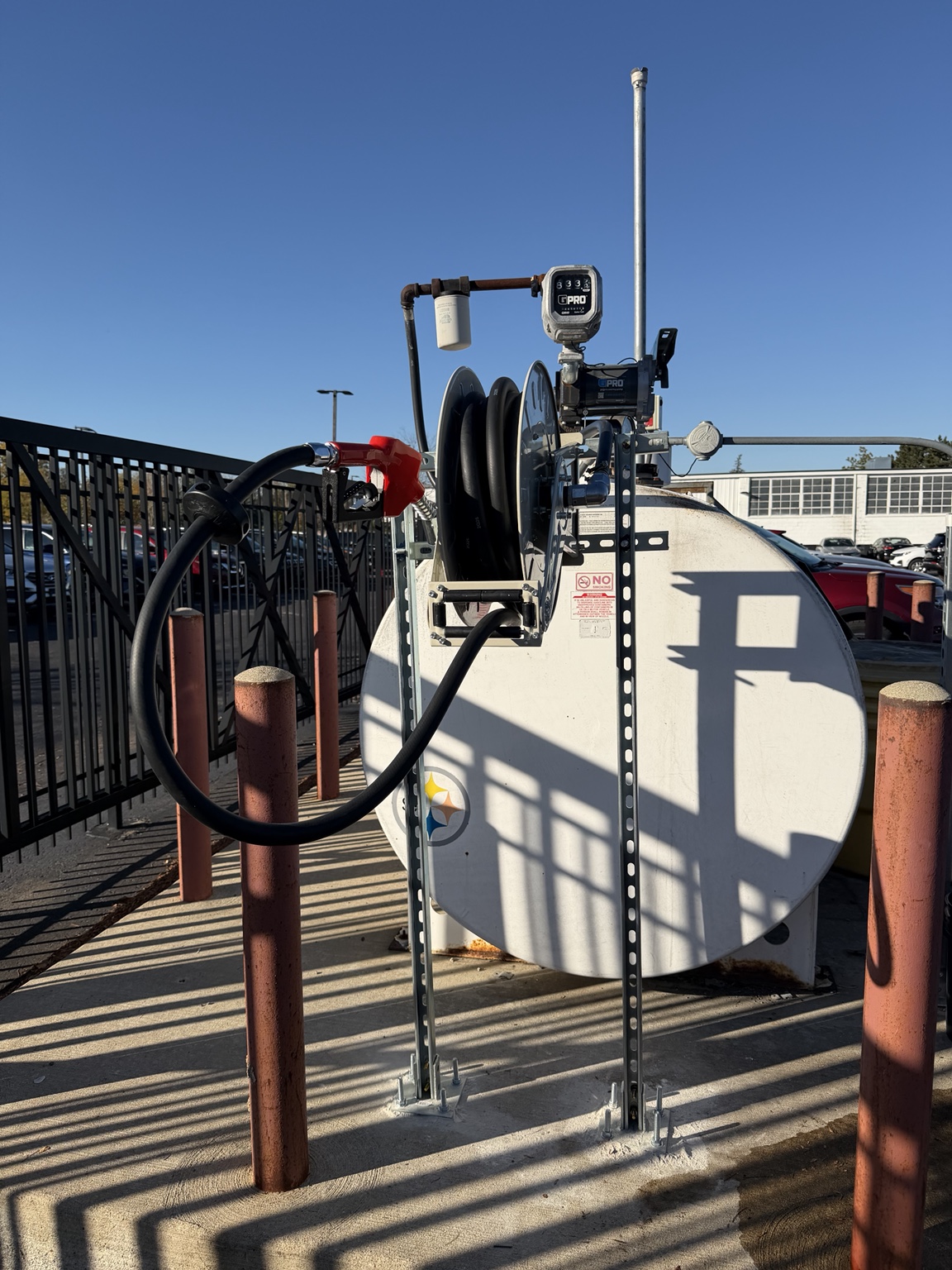 Installed fuel hose reel, nozzle, and anchored metal support frame at DriveTime